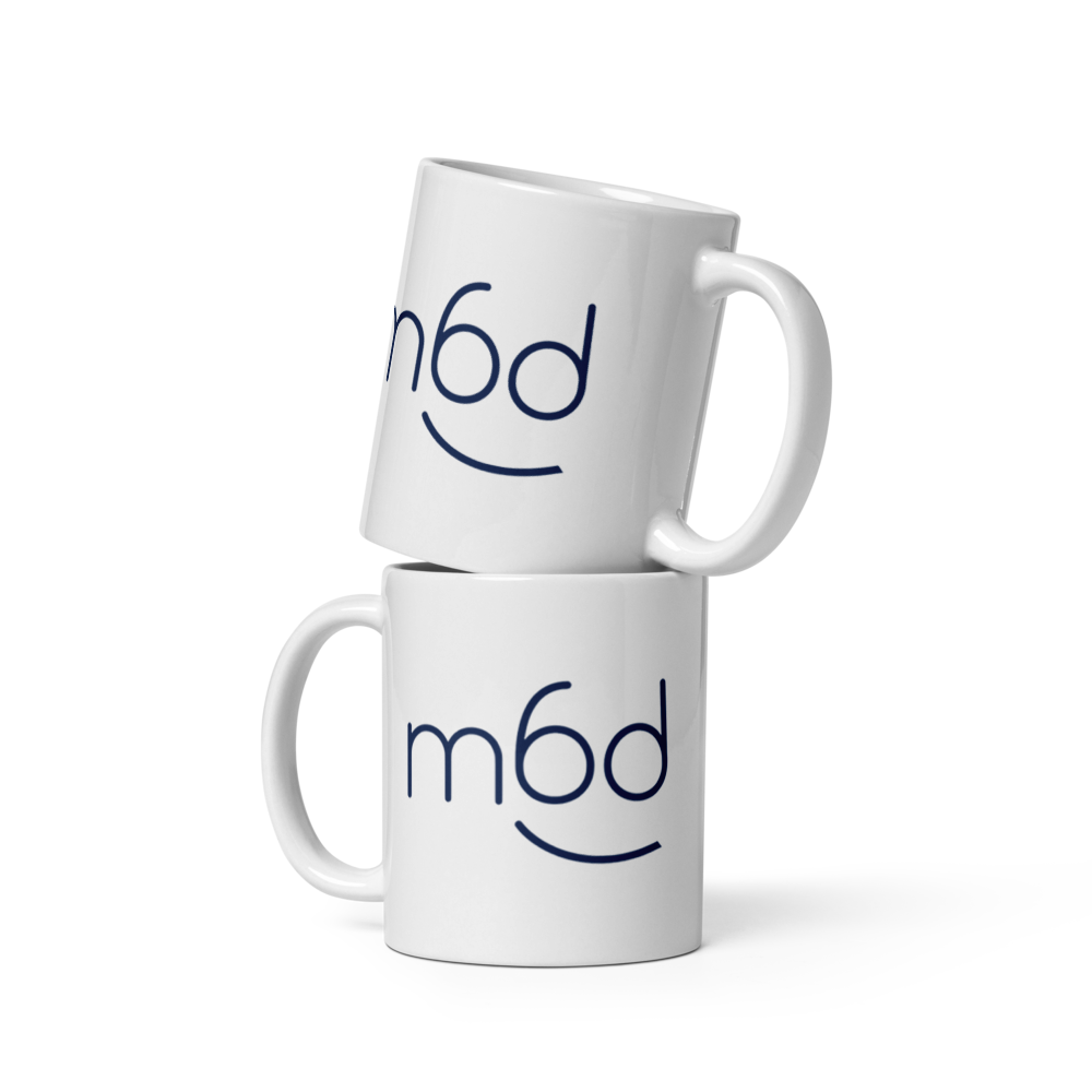Stacked unique mugs featuring the m6designer logo – minimalist design for coffee lovers.